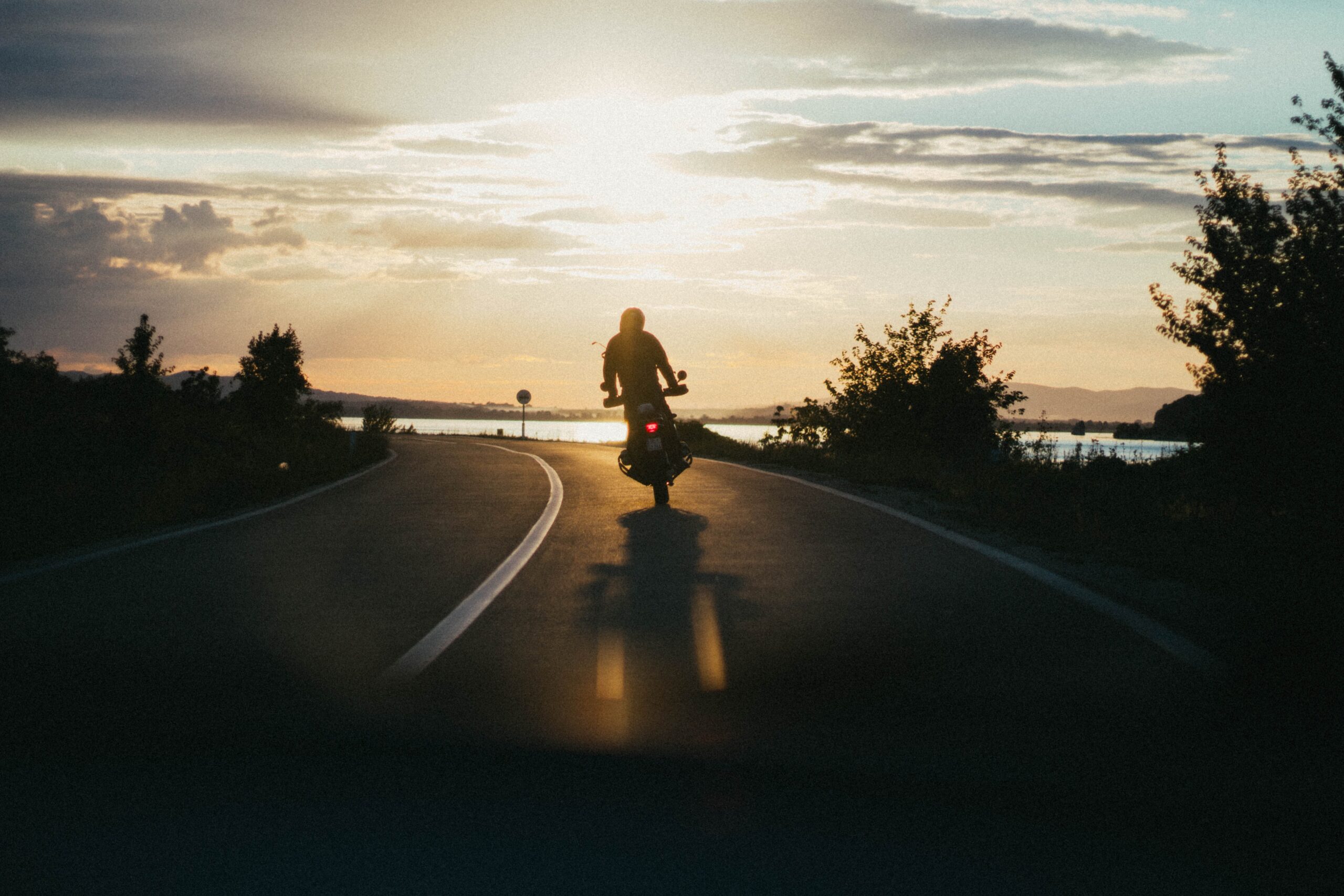 Motorcyclist riding on a sunny highway