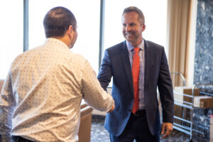 Attorney Kevin J Roach of Roach Law Car Accident Lawyers shakes the hand of a client